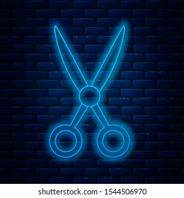 Glowing neon line Scissors hairdresser icon isolated on brick wall background. Hairdresser, fashion salon and barber sign. Barbershop symbol.  Vector Illustration