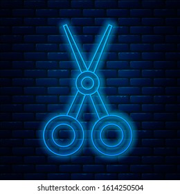 Glowing neon line Scissors hairdresser icon isolated on brick wall background. Hairdresser, fashion salon and barber sign. Barbershop symbol.  Vector Illustration