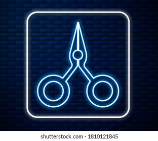 Glowing neon line Scissors icon isolated on brick wall background. Cutting tool sign.  Vector Illustration