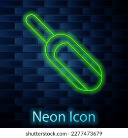 Glowing neon line Scoop flour icon isolated on brick wall background.  Vector