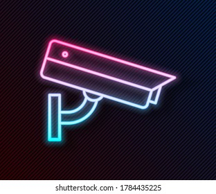 Glowing neon line Security camera icon isolated on black background.  Vector Illustration