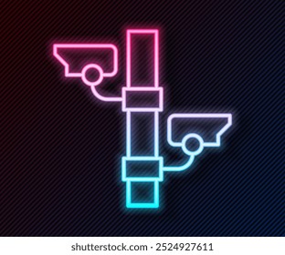Glowing neon line Security camera icon isolated on black background.  Vector