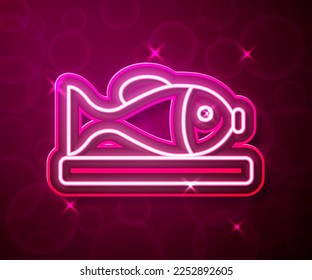 Glowing neon line Served fish on a plate icon isolated on red background.  Vector