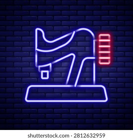 Glowing neon line Sewing machine icon isolated on brick wall background. Colorful outline concept. Vector