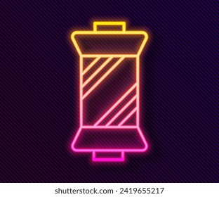 Glowing neon line Sewing thread on spool icon isolated on black background. Yarn spool. Thread bobbin.  Vector