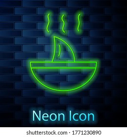 Glowing neon line Shark fin soup icon isolated on brick wall background. Vector.