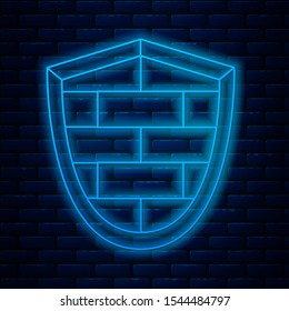 Glowing neon line Shield with cyber security brick wall icon isolated on brick wall background. Data protection symbol. Firewall logo. Network protection.  Vector Illustration