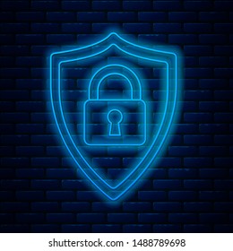 Glowing neon line Shield security with lock icon isolated on brick wall background. Protection, safety, password security. Firewall access privacy sign.  Vector Illustration