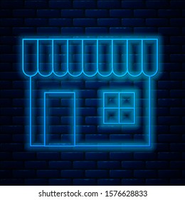 Glowing neon line Shopping building or market store icon isolated on brick wall background. Shop construction.  Vector Illustration