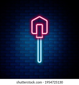 Glowing neon line Shovel icon isolated on brick wall background. Gardening tool. Tool for horticulture, agriculture, farming. Colorful outline concept. Vector