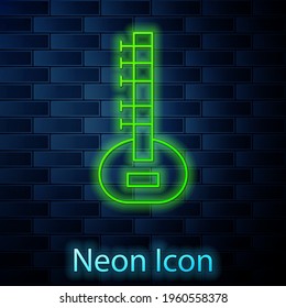 Glowing neon line Sitar classical music instrument icon isolated on brick wall background. Vector