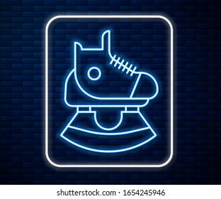 Glowing neon line Skates icon isolated on brick wall background. Ice skate shoes icon. Sport boots with blades.  Vector Illustration