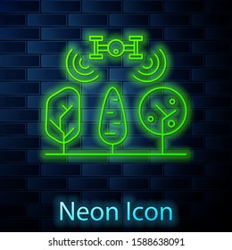 Glowing neon line Smart farm with drone control and tree icon isolated on brick wall background. Innovation technology for agricultural company.  Vector Illustration