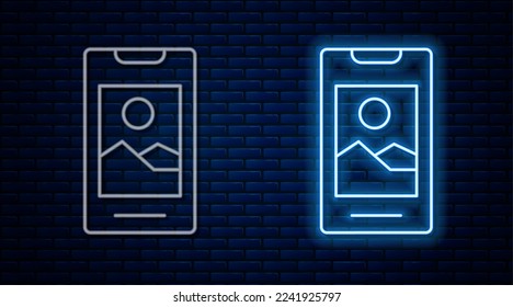 Glowing neon line Smartphone, mobile phone icon isolated on brick wall background.  Vector