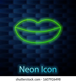 Glowing neon line Smiling lips icon isolated on brick wall background. Smile symbol.  Vector Illustration