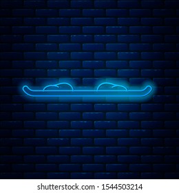 Glowing neon line Snowboard icon isolated on brick wall background. Snowboarding board icon. Extreme sport. Sport equipment.  Vector Illustration