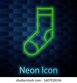 Glowing neon line Socks icon isolated on brick wall background.  Vector Illustration