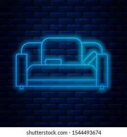 Glowing neon line Sofa icon isolated on brick wall background.  Vector Illustration