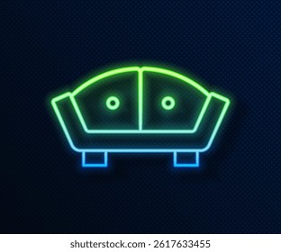 Glowing neon line Sofa icon isolated on blue background.  Vector