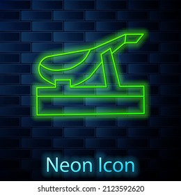 Glowing neon line Spanish jamon on the wooden jamonera icon isolated on brick wall background.  Vector