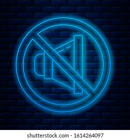 Glowing neon line Speaker mute icon isolated on brick wall background. No sound icon. Volume Off symbol.  Vector Illustration