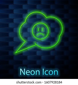 Glowing neon line Speech bubble with sad smile icon isolated on brick wall background. Emoticon face.  Vector Illustration