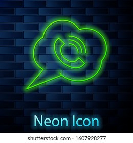 Glowing neon line Speech bubble with phone call icon isolated on brick wall background.  Vector Illustration