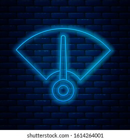Glowing neon line Speedometer icon isolated on brick wall background.  Vector Illustration