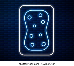 Glowing neon line Sponge with bubbles icon isolated on brick wall background. Wisp of bast for washing dishes. Cleaning service logo.  Vector Illustration