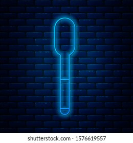 Glowing neon line Spoon icon isolated on brick wall background. Cooking utensil. Cutlery sign.  Vector Illustration