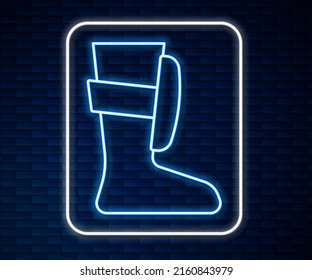 Glowing neon line Sport boxing shoes icon isolated on brick wall background. Wrestling shoes.  Vector