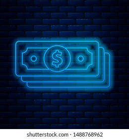 Glowing neon line Stacks paper money cash icon isolated on brick wall background. Money banknotes stacks. Bill currency.  Vector Illustration
