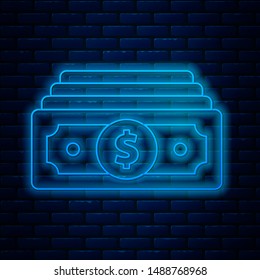 Glowing neon line Stacks paper money cash icon isolated on brick wall background. Money banknotes stacks. Bill currency.  Vector Illustration