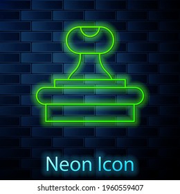 Glowing neon line Stamp icon isolated on brick wall background. Vector