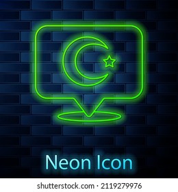 Glowing neon line Star and crescent - symbol of Islam icon isolated on brick wall background. Religion symbol.  Vector