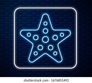 Glowing neon line Starfish icon isolated on brick wall background.  Vector Illustration