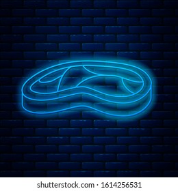 Glowing neon line Steak meat icon isolated on brick wall background.  Vector Illustration
