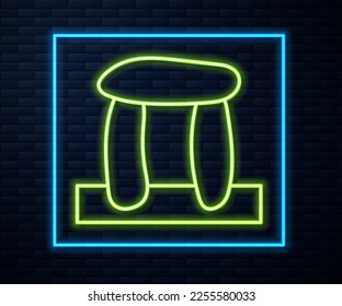 Glowing neon line Stonehenge icon isolated on brick wall background.  Vector