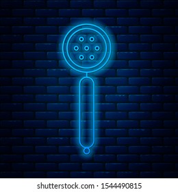 Glowing neon line Strainer spoon icon isolated on brick wall background.  Vector Illustration