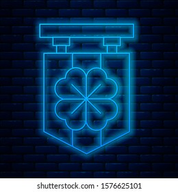 Glowing neon line Street signboard with four leaf clover icon isolated on brick wall background. Suitable for advertisements bar, cafe, pub.  Vector Illustration