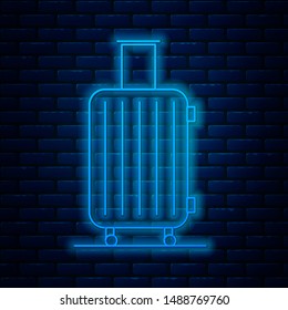 Glowing neon line Suitcase for travel icon isolated on brick wall background. Traveling baggage sign. Travel luggage icon.  Vector Illustration