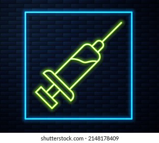 Glowing neon line Syringe with serum icon isolated on brick wall background. Syringe for vaccine, vaccination, injection, flu shot. Medical equipment.  Vector