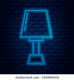 Glowing neon line Table lamp icon isolated on brick wall background.  Vector Illustration
