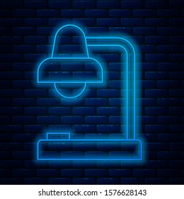 Glowing neon line Table lamp icon isolated on brick wall background. Table office lamp.  Vector Illustration