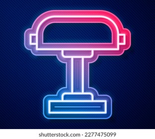 Glowing neon line Table lamp icon isolated on blue background. Desk lamp.  Vector