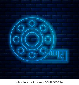 Glowing neon line Tape measure icon isolated on brick wall background. Measuring tape.  Vector Illustration