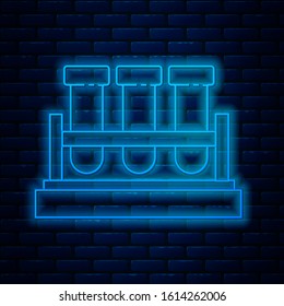 Glowing neon line Test tube and flask chemical laboratory test icon isolated on brick wall background. Laboratory glassware sign.  Vector Illustration