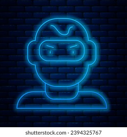 Glowing neon line Thief mask icon isolated on brick wall background. Bandit mask, criminal man.  Vector