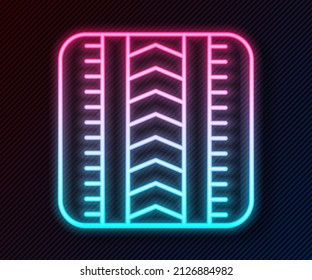 Glowing neon line Tire track icon isolated on black background.  Vector