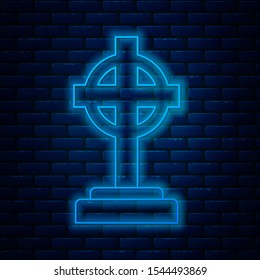 Glowing neon line Tombstone with cross icon isolated on brick wall background. Grave icon.  Vector Illustration